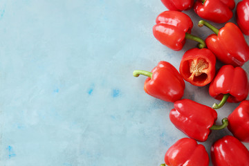 Ripe red peppers on color background