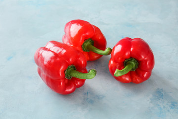 Ripe red peppers on color background