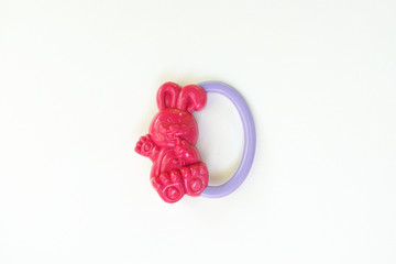 newbor toy bunny. A colorful baby rattle on a white horizontal background