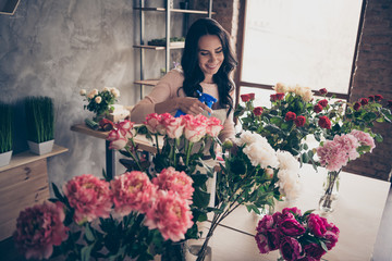 Close up photo beautiful adorable she her lady many roses vases retail seller assistant hands arms check flowers condition pulverize fertilizer water opening service small flower shop room indoors