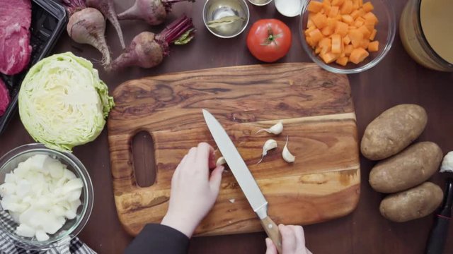 Step by step. Flat lay. Crushing garlic for beet soup, borscht.