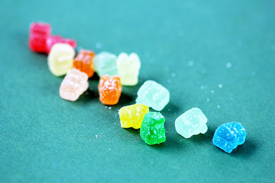cbd gummy bears vitamin on green background