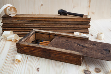 Toolbox with wood cutters on wooden background.