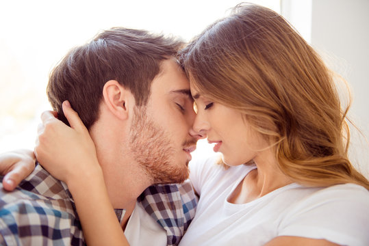 Close-up portrait of his he her she nice-looking caucasian sweet attractive charming bearded guy kissing lady life partners in light white style interior hotel house indoors
