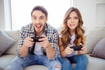 Portrait of his he her she two person nice-looking attractive charming lovely guy lady playing online internet station in light white style interior hotel house indoors