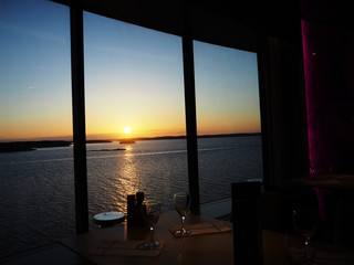 Fototapeta premium Cruise ship, with table and chair in the sunset at sea