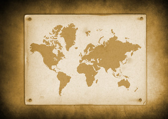 Vintage world map parchment nailed to a wall