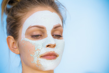 Girl removes dry white mud mask