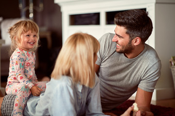 Happy parents with daughter playing