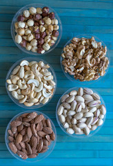 Healthy food. Nuts mix assortment on stone texture top view. Collection of different legumes for background image close up nuts, pistachios, almond, cashew nuts, peanut, walnut. image