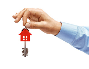 Man's hand in shirt holds house keys isolated on white background. High resolution product. Close up.