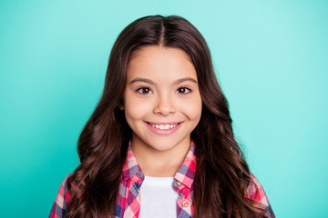 Close-up portrait of her she nice attractive lovely winsome sweet cute cheerful cheery wavy-haired pre-teen girl wearing checked shirt isolated on bright vivid shine blue background