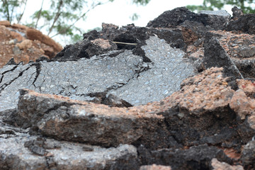 Naklejka premium pieces of asphalt road on the ground to be recycled.