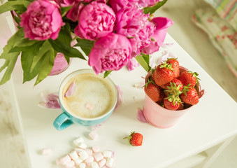 Delicate bouquet of peonies and strawberries. Atmosphere of rest and relaxation.
