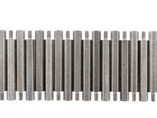 An assortment of iron standoffs or spacers