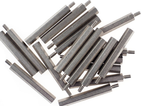 An assortment of iron standoffs or spacers