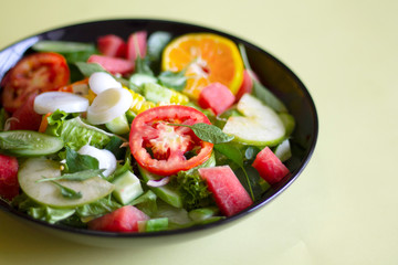 Selective focus Salmon Fresh green Salad with spinach, cherry tomatoes,baby spinach, Concept for a tasty and healthy meal. Dark stone background. Top view. Close up.