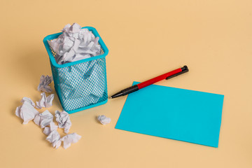 crumpled paper trash and stationary with note paper placed in the trash can