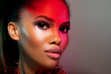 Beauty portrait fashion girl with color lighting filters. Beauty girl face close up. Closeup...