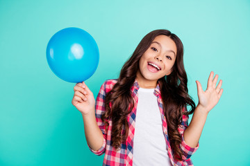 Portrait of her she nice cute attractive cheerful wavy-haired girl in checked shirt holding in hand ball festive celebratory having fun isolated on bright vivid shine green blue turquoise background