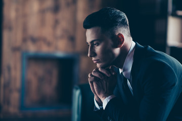 Close up side profile photo handsome moody he him his pensive ponder hands arms hold head chin not smiling self-confident wear formal-wear shirt jacket tie suit costume indoors modern office place