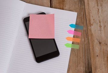 Note book four arrow banners smartphone sticky note old wooden background