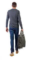 back view of walking  man  with green bag.