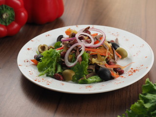 Salad with meat, olives, onions, beans and pepper