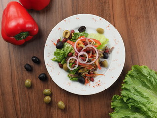 Salad with meat, olives, onions, beans and pepper