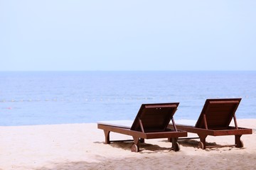 Naklejka na ściany i meble Wooden beach bed on sandy beach closeup nature ocean view landscape background