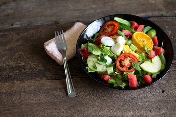 Healthy and tasty food: salad of zucchini, tomatoes, lettuce with lime and spices close-up on a plate on the table. horizontal 