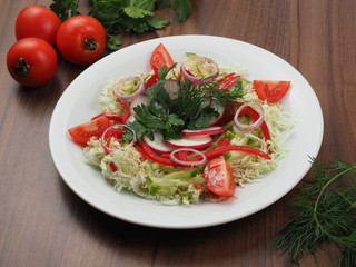 Salad of cucumbers, tomatoes, radishes and cabbage
