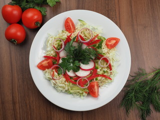 Salad of cucumbers, tomatoes, radishes and cabbage
