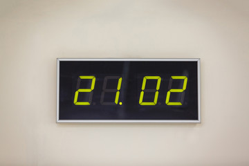 Black digital clock on a white background showing time 21.02 minutes