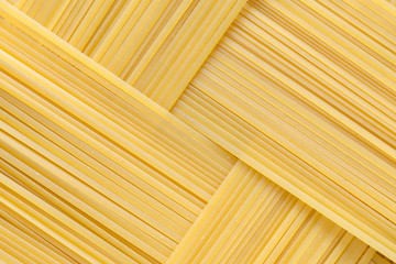 Diagonal geometric pattern of pasta bavette. Background image of pasta from durum wheat.