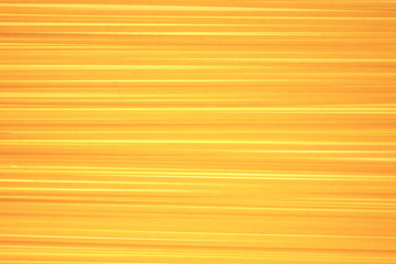 Abstract background of raw pasta in the form of luminous lines. Macaroni Bavette. National Italian cuisine.