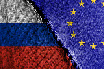 The gap between the two flags, Russia and European Union, as a concept of political confrontation.