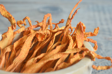 dried cordyceps militaris mushroom flower on wooden background. 