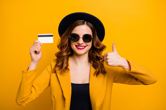 Close up photo beautiful she her lady hands arms credit plastic card thumb up symbol advising buyer vacation traveler sale discount wear specs formal-wear suit isolated yellow bright background