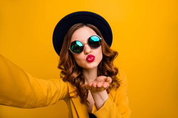 Close up photo beautiful dreamy funky she her lady make take selfies send air kiss boyfriend vacation red pomade lips lipstick wear hat sun specs formal-wear suit isolated yellow bright background