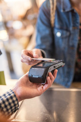 Focus on a contactless card payment with the terminal 