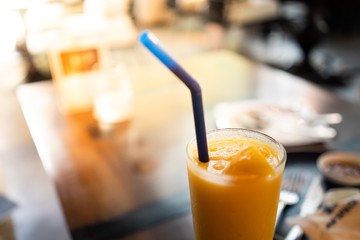 glass of peachjuice on table in cafe