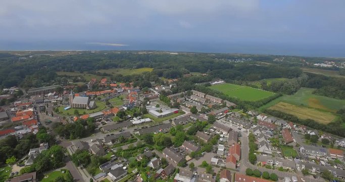 The small touristic town Renesse in the Netherlands during a light overcast day in summer. Aerial shot.