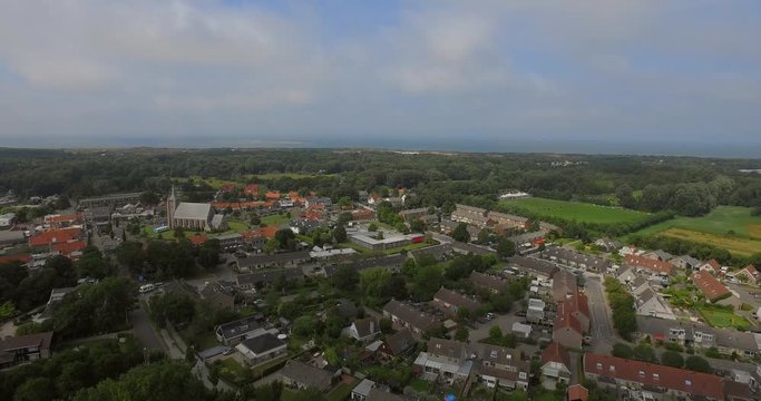 The small touristic town Renesse in the Netherlands during a light overcast day in summer. Aerial shot.