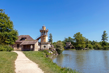 Fototapeta na wymiar Queen’s Hamlet, small village around Big Lake at Versailles Royal palace next to Small Trianon