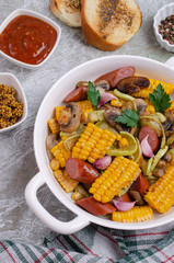 Slices of fried vegetables with sausages