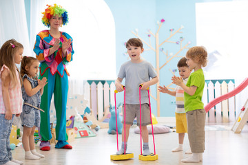 Fototapeta na wymiar happy children and clown on birthday party indoors
