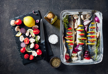 three whole raw mackerel in a baking pan