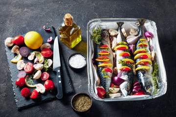 three whole raw mackerel in a baking pan