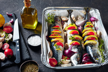 three whole raw mackerel in a baking pan